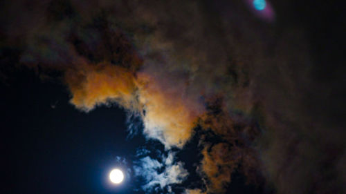 Low angle view of moon in sky at night