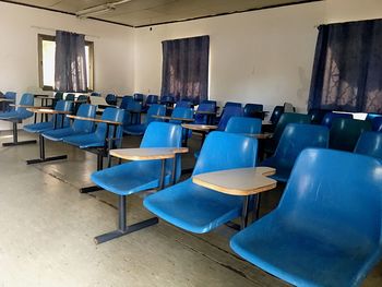 Empty chairs and table in room