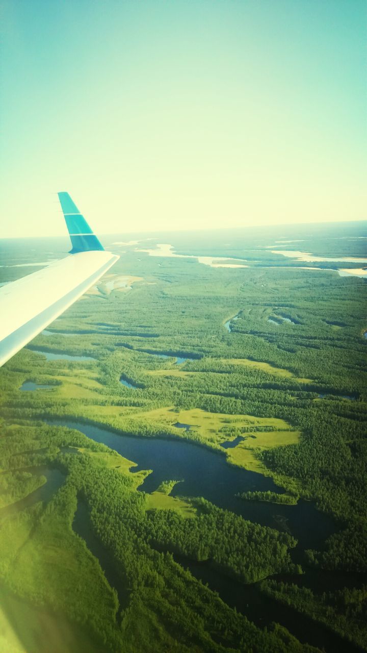 transportation, aerial view, airplane, landscape, blue, scenics, tranquil scene, flying, sea, air vehicle, clear sky, beauty in nature, mode of transport, tranquility, nature, aircraft wing, travel, copy space, horizon over water, sky