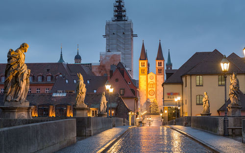 Illuminated buildings in city at dusk