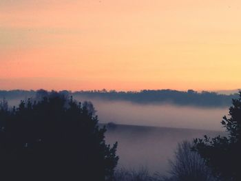 Scenic view of lake against sky at sunset