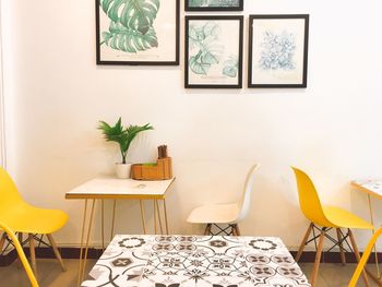 Empty chairs and table against wall at home