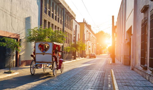 Street amidst buildings in city against sky