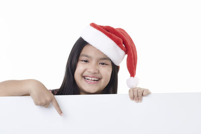 Portrait of a smiling young woman against white background