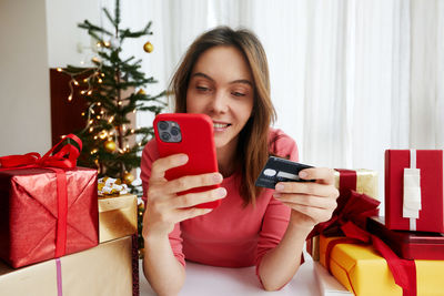 Woman making payment online before christmas celebration