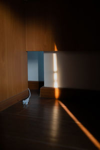 Empty wooden table against wall