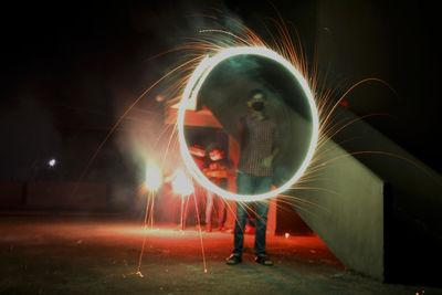 Man with light painting at night