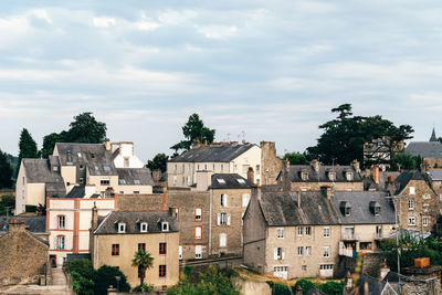 Old cobblestoned street with stone medieval houses in the town centre of dinan, french brittany