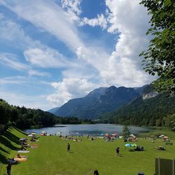 Panoramic view of people on landscape against sky