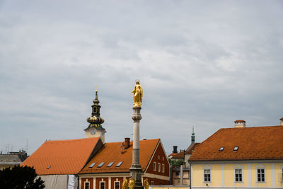 Low angle view of building against cloudy sky