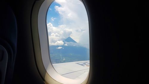 Cloudy sky seen through airplane window