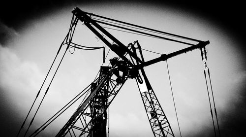 Low angle view of crane against sky