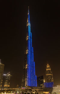 Illuminated modern buildings in city at night