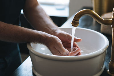 Cropped hand of man preparing food