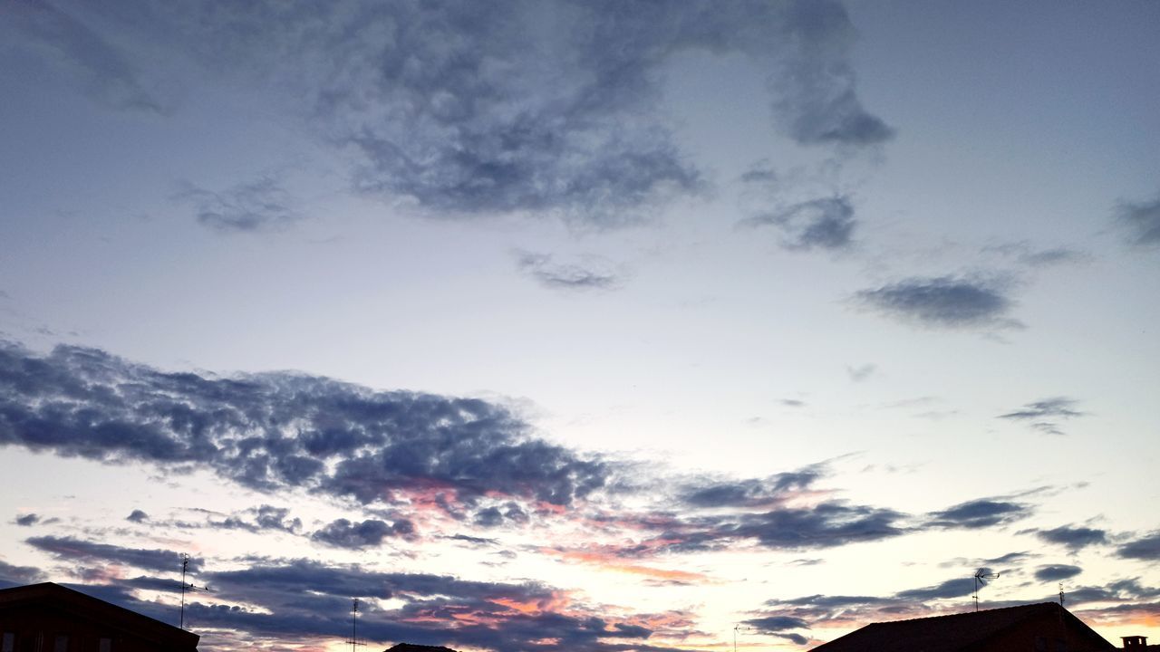 LOW ANGLE VIEW OF SILHOUETTE HOUSES AGAINST SKY