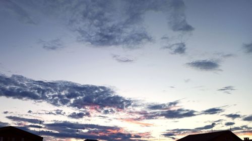 Low angle view of silhouette buildings against sky