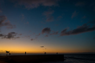 Scenic view of beach against sky during sunset