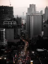 High angle view of traffic on road amidst buildings in city