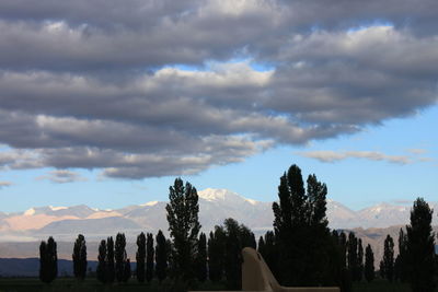 Scenic view of mountains against cloudy sky