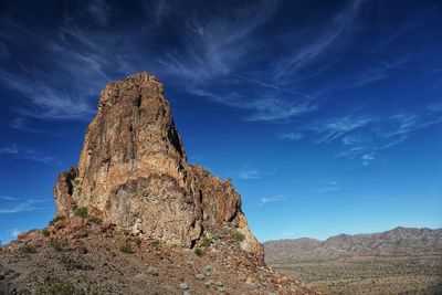 Low angle view of rock formation against sky