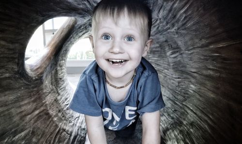 Portrait of smiling boy in wood