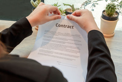 Midsection of people holding paper