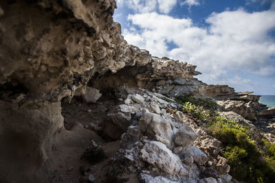Low angle view of rock formation against sky