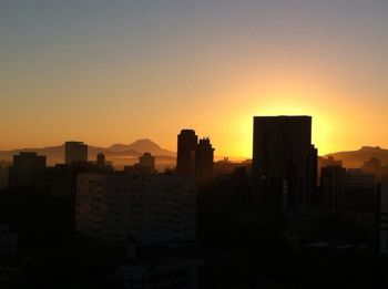 Silhouette of city at sunset