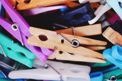 High angle view of multi colored clothespins on metal