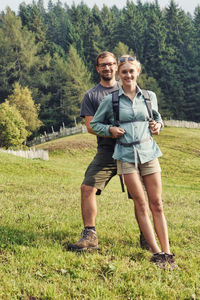 Full length portrait of couple standing on land