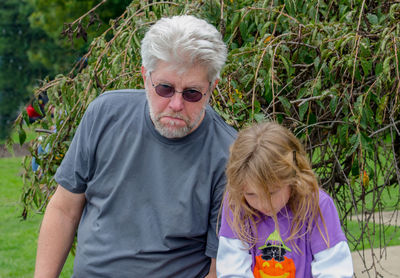 Grandpa and granddaughter are sad their fun day has to end and it's time to go home