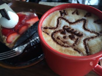 Close-up of cappuccino served on table