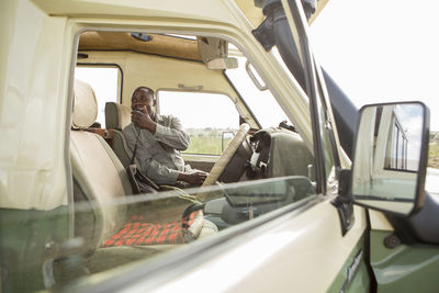 Park ranger talking on cb radio while sitting in car