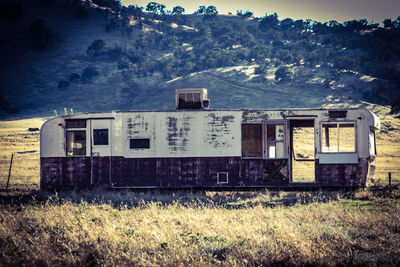 Abandoned house on field