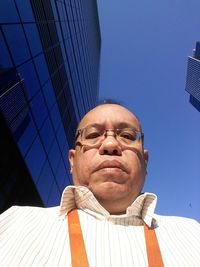 Portrait of man against blue sky