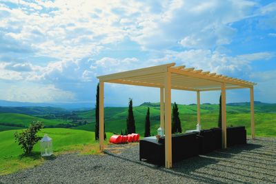 Gazebo on field against sky