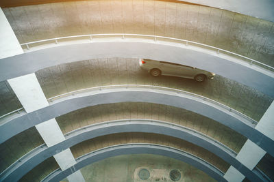 Up-down of the parking lot, way up - into the building's parking lot with a curved section.