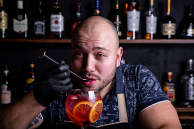 Portrait of man holding drink