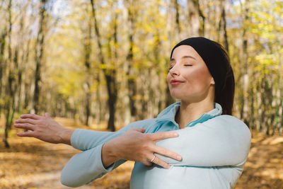 Girl doing fitness in nature on a sunny autumn forest