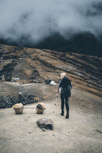 Full length of man standing on mountain road