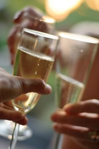 Close-up of hand holding beer glass