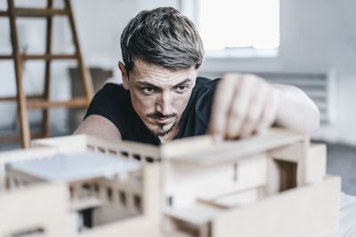 Architect working on architectural model