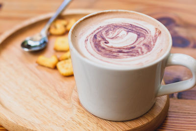 Close-up of cappuccino served on table