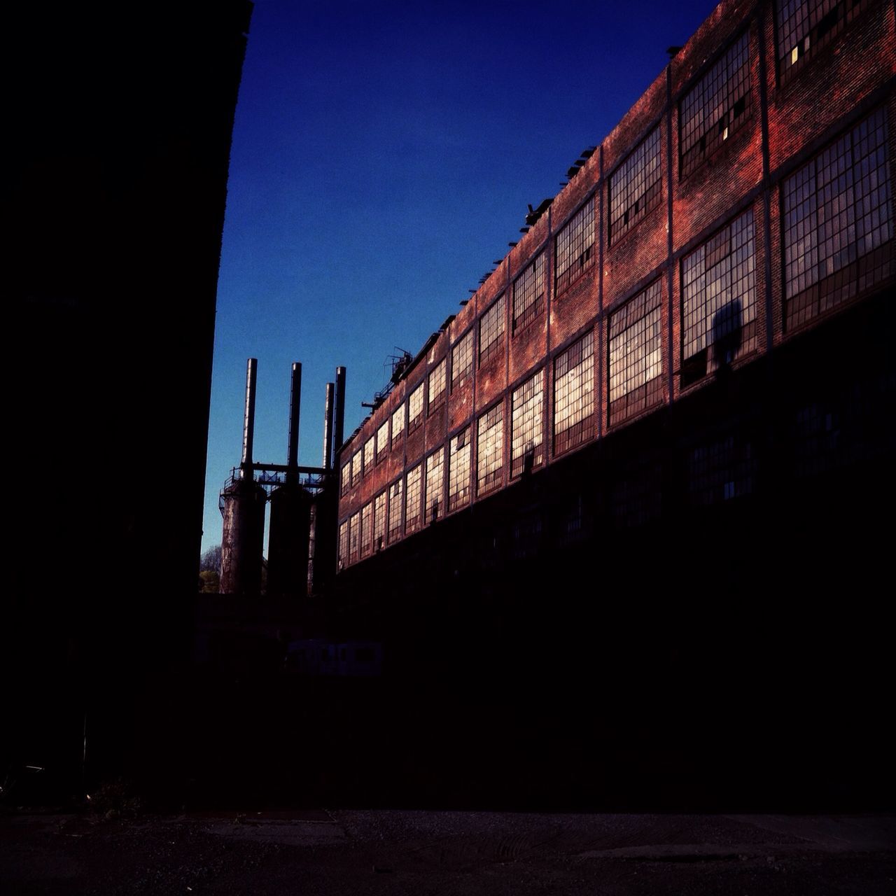 architecture, built structure, building exterior, clear sky, illuminated, night, city, copy space, blue, sky, building, dusk, low angle view, silhouette, outdoors, dark, no people, exterior, travel destinations, window