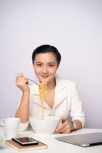 Portrait of a young woman eating food
