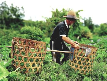 Full length of man in basket on field