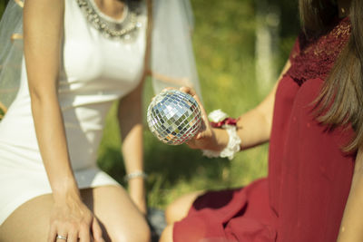 Girl holding ball. girls on picnic. details of outdoor recreation. women in summer in park.