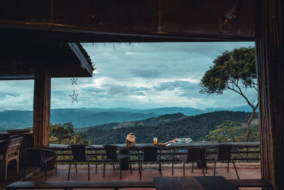 Scenic view of restaurant by mountains against sky