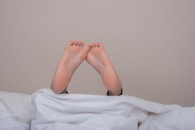 Low section of person lying on bed
