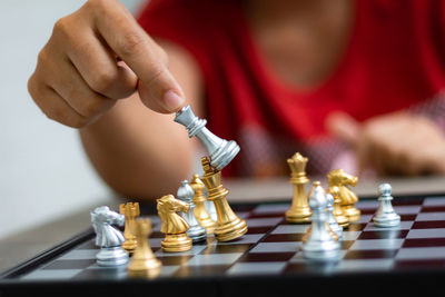 Cropped image of woman playing chess